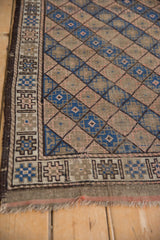 Vintage Belouch rug with geometric border and blue, beige, rose diamond lattice.