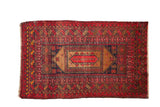 Vintage Afghan rug with lozenge medallion, ram's horn borders, cherry red, navy, coffee brown.