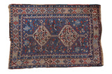 Vintage Kamseh rug with a double interconnected medallion, animal motifs, and a sapphire blue and red palette.