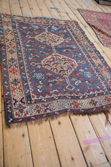 Perspective view of a hand-knotted Kamseh rug highlighting its time-softened texture and geometric medallions.