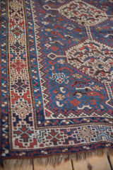 Angled view of the vintage Kamseh rug's geometric border, showing the low pile and texture.