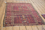 Antique Turkmen rug detail: serrated leaf border, ram's horn motif, and visible foundation wear.