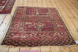Antique Turkmen rug, lower corner showing ram's horn and serrated leaf borders, fringe, and worn pile.