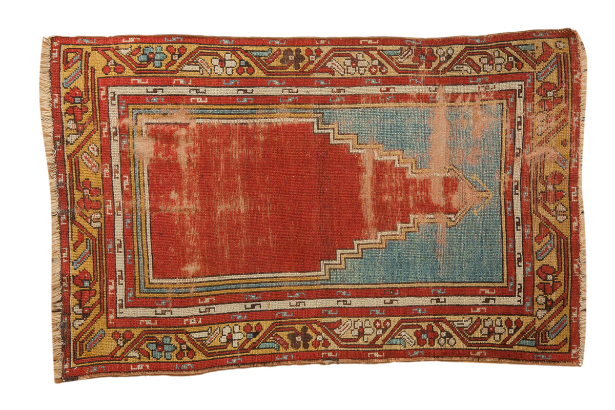Vintage Anatolian prayer rug featuring a red and blue stepped mehrab motif with decorative serpent borders.