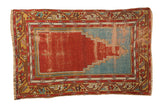 Vintage Anatolian prayer rug featuring a red and blue stepped mehrab motif with decorative serpent borders.