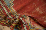 Detailed view of the stepped border and worn cherry red pile on a vintage Anatolian rug.