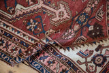 Vintage Hamadan rug detail: geometric border and Herati-inspired motifs in red, navy, and blush.