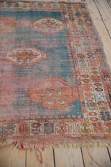 Angora Oushak rug: faded field, inverted medallions, worn pomegranate border, tattered fringe.