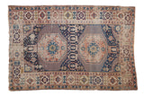 Antique Shirvan rug with double stepped medallions, Kufic border in navy, terracotta, and sand hues.