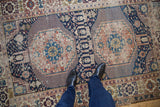 Antique Shirvan rug with bold double medallions, geometric field, and Kufic border in navy and terracotta.