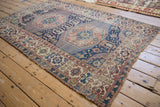 Antique Shirvan rug displaying Kufic border, geometric stepped medallion, navy and terracotta field.