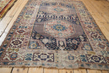 Antique Shirvan rug's geometric Kufic border, navy field, and visible storied repair.