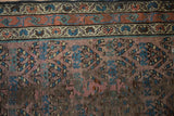 Aubergine ground with blue boteh pattern, abrashes, and wear on antique Kurdish Hamadan runner.