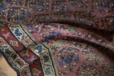 Aubergine field, shadow boteh motif, and madder red border of an antique Kurdish runner.