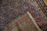 Antique Kurdish Hamadan runner folded, showing aubergine shadow boteh pile and intricate woven reverse.