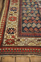 Vintage Caucasian runner corner with blue botehs, red crab style and pawn borders.