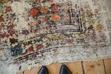 Tattered fringe and worn patterns at the end of the vintage Caucasian runner.