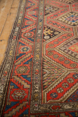 Vintage Kurdish Hamadan runner detail: cochineal diamond motifs, snowflake guls, and geometric side border.