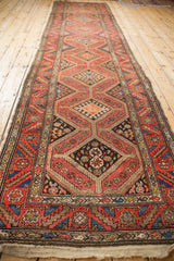 Vintage Kurdish Hamadan rug runner border, featuring dusty red, teal, and brown geometric patterns.