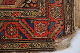 Vintage Kurdish Hamadan rug runner showing tattered fringe and a worn geometric border.