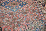 Vintage Malayer rug with time-softened brick red Herati field and sapphire blue border.