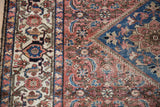 Malayer rug border with palmettes, Herati field, in time-softened brick red and sapphire.