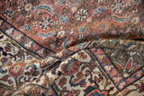 Contrasting Malayer rug fold, faded brick red Herati field meets beige palmette border.