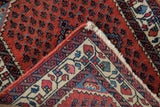 Hand-knotted foundation and dense wool pile seen on the folded corner of a vintage Persian rug.