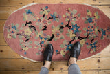 Art Deco Nichols oval runner displaying dusty rose field, black branches, colorful lotus flowers.