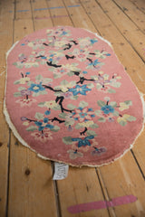 Art Deco Nichols rug showing black branches, dusty blush, pastel lotus blossoms, tattered edges.