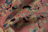 Folded vintage Nichols Art Deco rug highlighting black dragon branches and pastel lotus flowers.