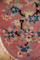 Tattered edge of a vintage Nichols Art Deco rug, with black dragon branches and colorful lotus blossoms.