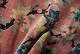 Textured Nichols Art Deco rug with dusty rose, blue lotus, and rare black dragon-like branches.
