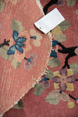 Vintage Nichols Art Deco rug's woven back, dusty rose pile, black dragon, tattered edge.