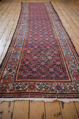 A long angled view displays the intricate Herati design of a vintage Malayer rug runner.