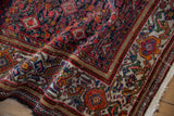 Worn texture of a vintage Persian Malayer runner's intricate samovar turtle border.