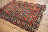 Vintage Hamadan rug with red and navy Herati motif, distinct border, visible wear, tatter.
