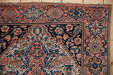 Traditional vintage Farahan Sarouk rug corner, with coral, navy, teal palmettes and vinery.