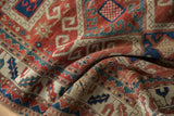 Hand-knotted Caucasian Kazak rug exhibiting cherry red, navy, and ivory geometric motifs.