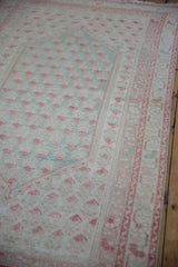 Faded mint green and ivory distressed Oushak rug with pale raspberry boteh pattern.