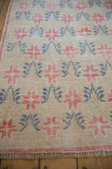 Detailed view of the distressed pile showing even wear over the starburst blossoms.