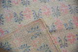 Close-up of the hand-knotted back and distressed low pile of a vintage Oushak rug.