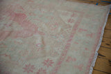 Evenly worn, low pile texture of a vintage Oushak runner's pink and sand border design.