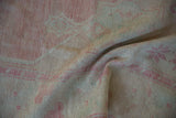 Texture detail of the distressed Oushak showing even wear across the knot heads.