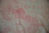 Faded bubblegum pink and beige knot heads showing the even wear of the vintage runner.