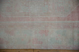 Visible knot heads and faint foundation showing the even wear of a distressed Oushak rug.