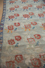 Vintage Distressed Oushak runner, cherry red rose bouquets, blue geometric border.