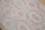 Detailed view of the distressed Oushak rug's texture, showing even wear to the knot heads.