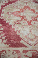 Detailed texture of a distressed Turkish carpet with even wear and the foundation showing through.