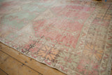 Distressed Oushak runner with worn mint green, faded raspberry panels, geometric border.